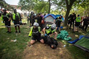 Toronto police detain encampment supporters as they clear the Lamport Stadium Park encampment in Toronto on Wednesday July 21, 2021.