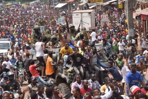 People celebrate in the streets with members of Guinea's armed forces after the arrest of Guinea's president, Alpha Conde.