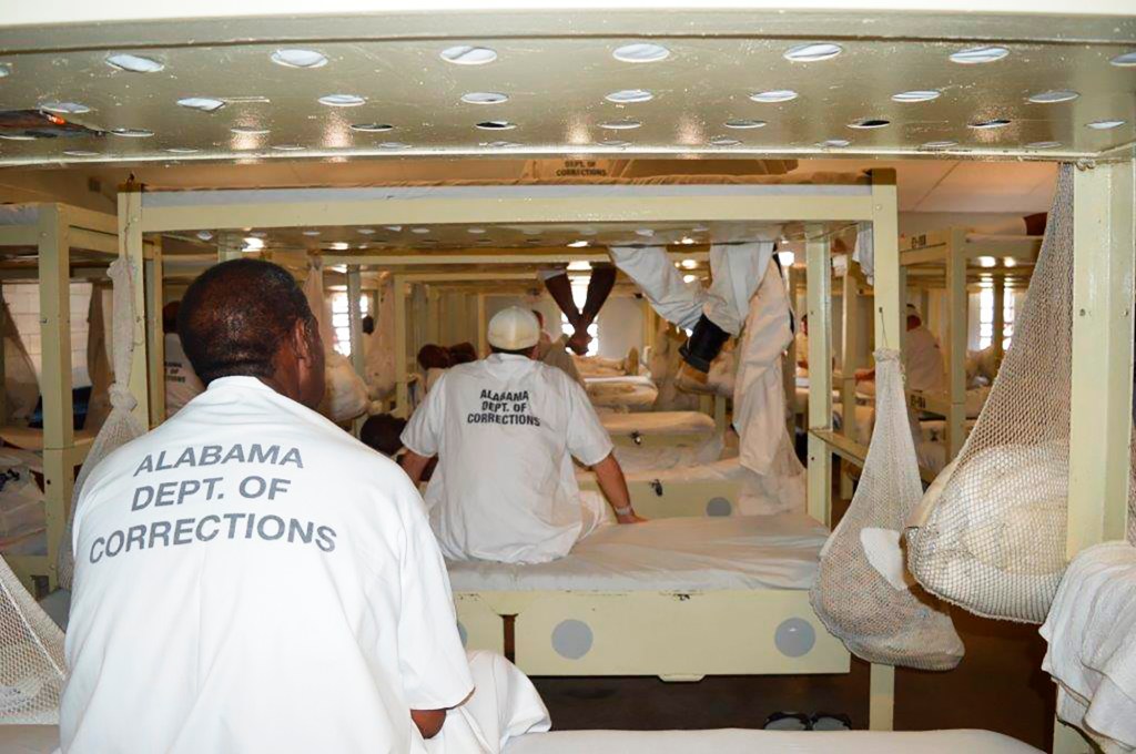 Inmates sit in a treatment dorm at Staton Correctional Facility in Elmore, Ala., Wednesday, Sept. 4, 2019. The Department of Justice has threatened to sue Alabama over excessive violence and other problems in state prisons for male inmates. (AP Photo/Kim