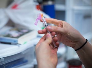 A volunteer at a safe injection site in Toronto prepares syringes with Naloxone in 2018.