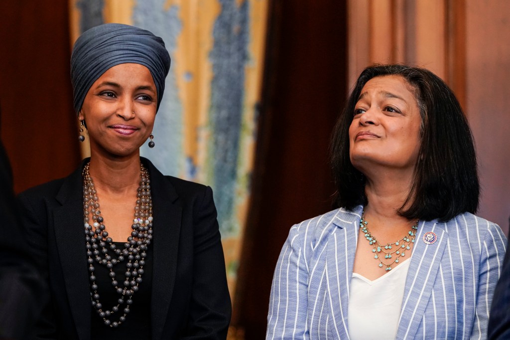 Reps. Ilhan Omar (D-MI) and Pramila Jayapal (D-WA) listen as Speaker of the House Nancy Pelosi (D-CA) holds a bill enrollment signing ceremony for the Juneteenth National Independence Day Act on June 17, 2021 on Capitol Hill in Washington, DC.