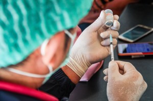 A health worker prepares a dose of the Moderna Covid-19 vaccine to be administered.