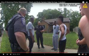 Eric Brown, Roy Thorne, and his 15-year-old son being questioned by Wyoming, Michigan, police on August 1, 2021 while viewing a vacant house.