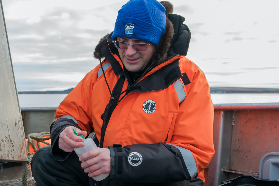 Alex Whiting takes a water sample off the coast of Kotzebue, Alaska.