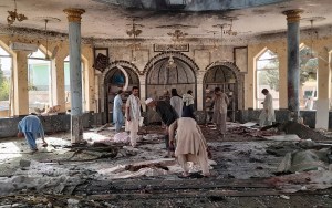 People view the damage inside of a mosque following a bombing in Kunduz, province northern Afghanistan, Friday, Oct. 8, 2021.