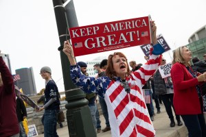 A Trump supporter holds a sign at a protest during the 2020 Presidential election outside the TCF Center in Detroit, Michigan, U.S., on Thursday, Nov. 5. 2020 (Emily Elconin/Bloomberg via Getty Images​)