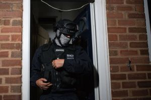 The National Crime Agency and police raiding a Birmingham property in 2020​ as part of an investigation into organised crime