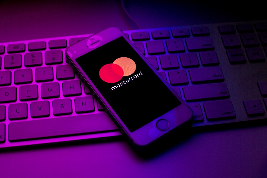 A cell phone with the Mastercard logo on a keyboard. Getty Images.