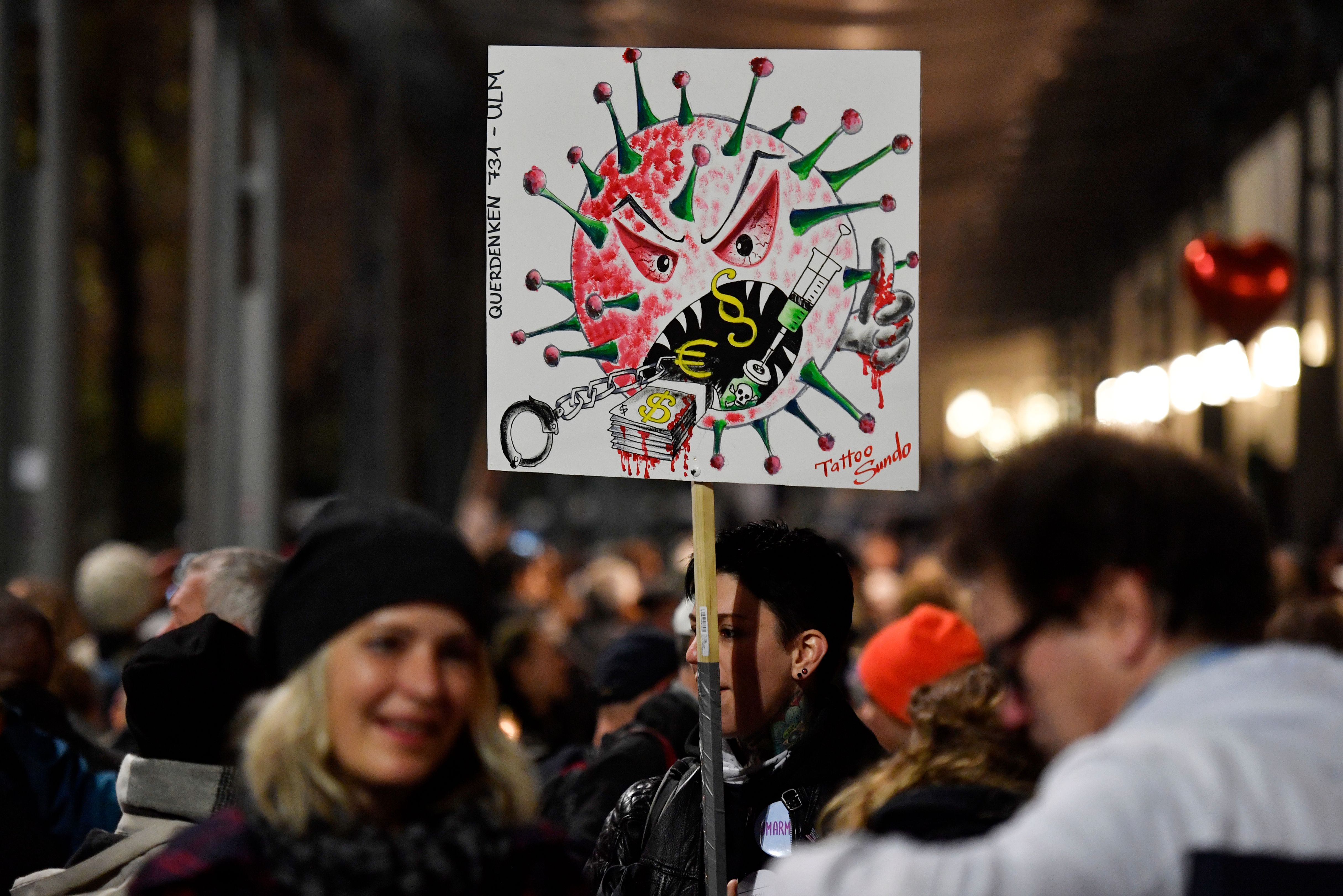 A demonstrator holds up a placard at a anti-COVID restrictions protest organised by Querdenken in Leipzig last November. Photo: JOHN MACDOUGALL/AFP via Getty Images