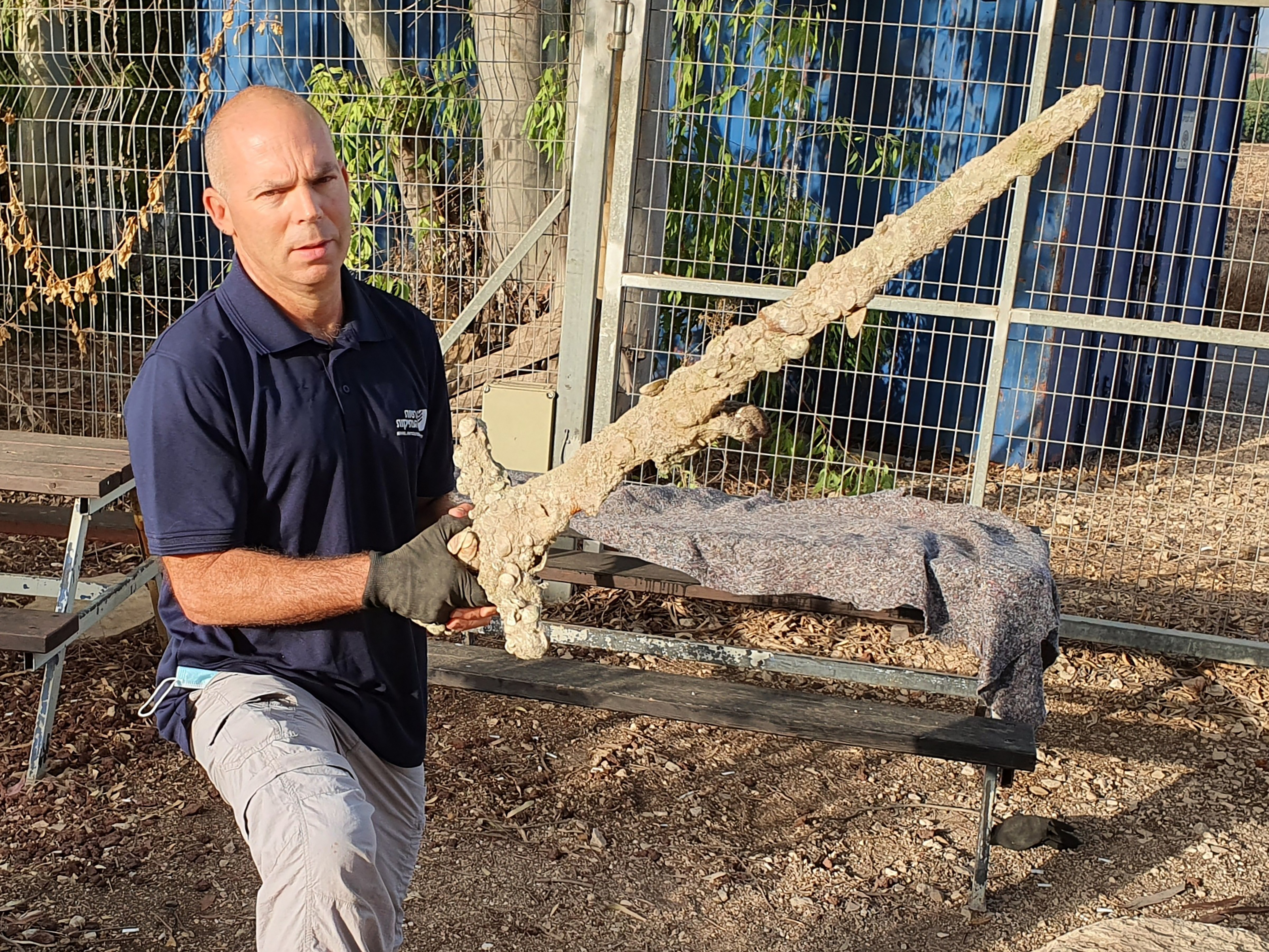 Nir Distelfeld, Inspector for the Israel Antiquities Authority's holds an ancient sword after it was discovered by an Israeli diver off the country's Mediterrean coast near Haifa. Photo: Associated Press