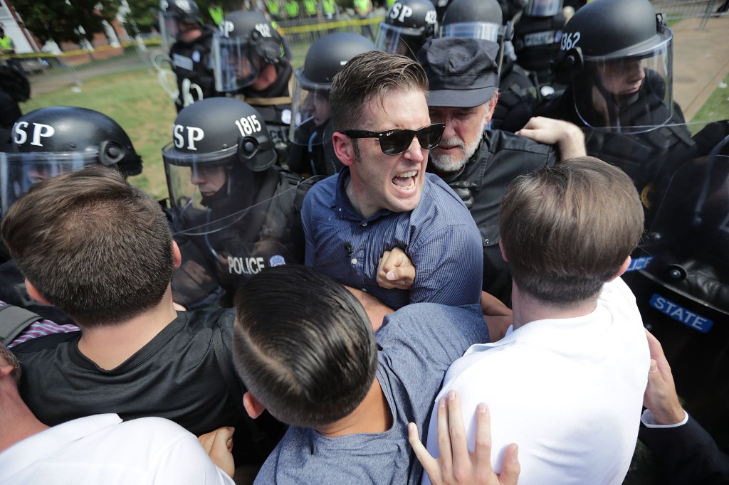 White nationalist Richard Spencer (C) and his supporters clash with Virginia State Police in Emancipation Park after the "Unite the Right" rally was declared an unlawful gathering August 12, 2017 in Charlottesville, Virginia.