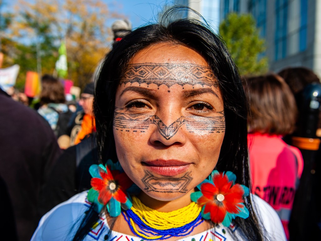 An Indigenous woman with tribal tattoos in her face is posing to the camera before the demonstration Back to Climate started in Brussels, on October 10th, 2021.