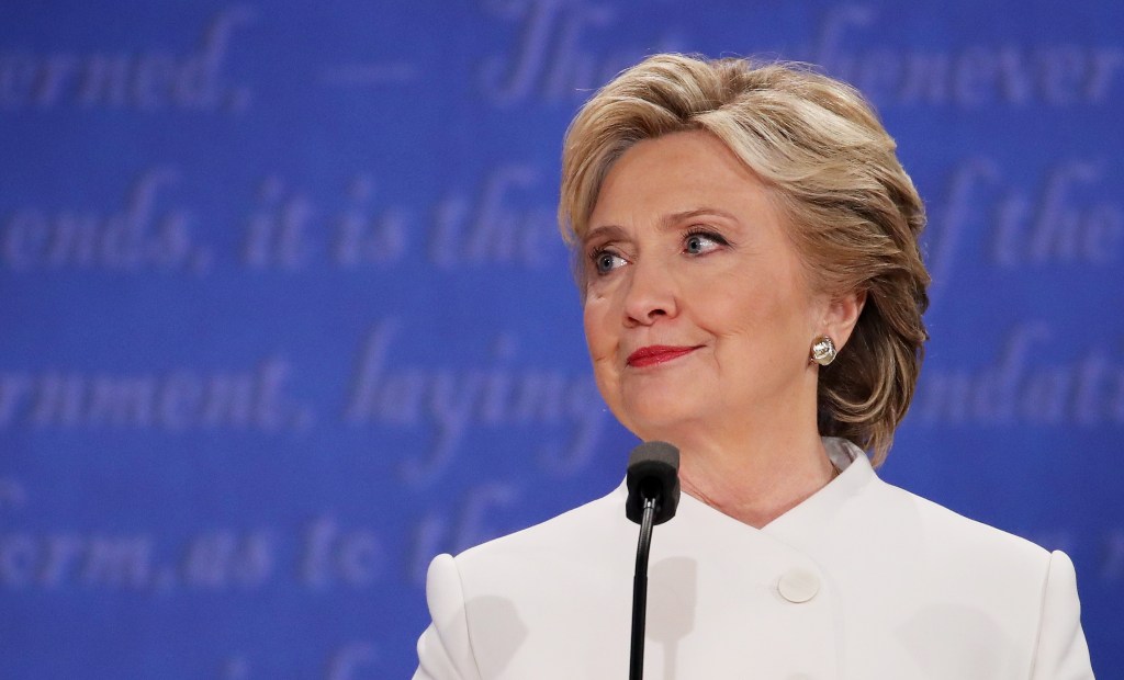 Democratic presidential nominee former Secretary of State Hillary Clinton listens to Republican presidential nominee Donald Trump speak during the third U.S. presidential debate at the Thomas & Mack Center on October 19, 2016 in Las Vegas, Nevada. (Drew A