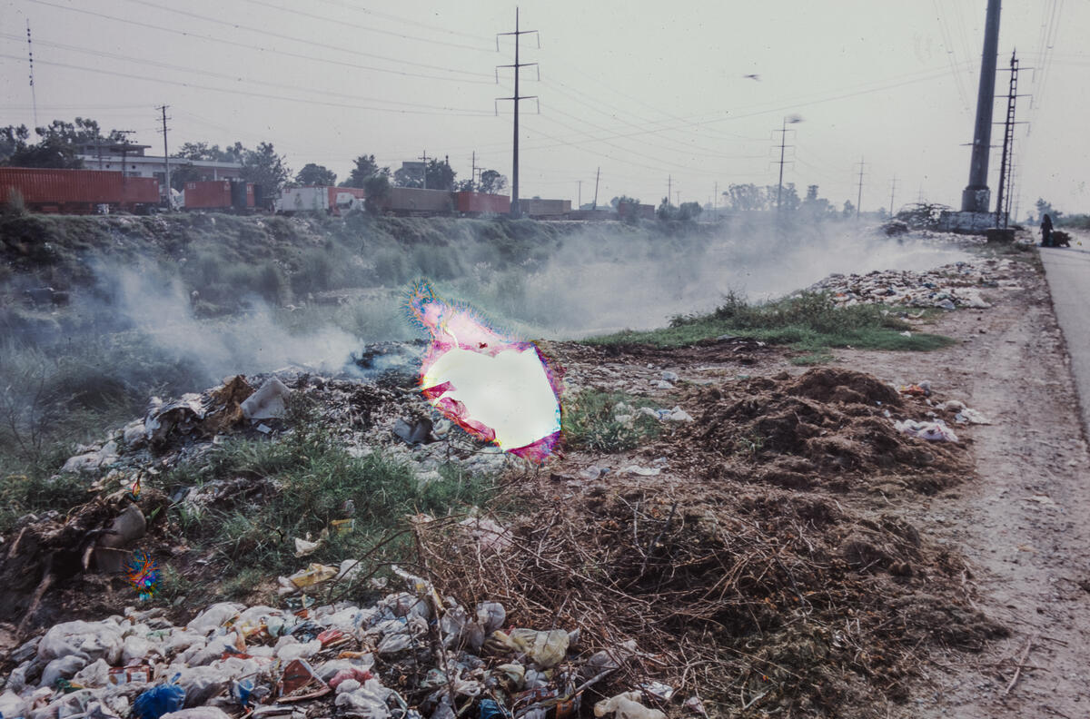 Rubbish and waste burns along the canals of Lahore, Pakistan. Image: Nad É Ali / Save the Children  