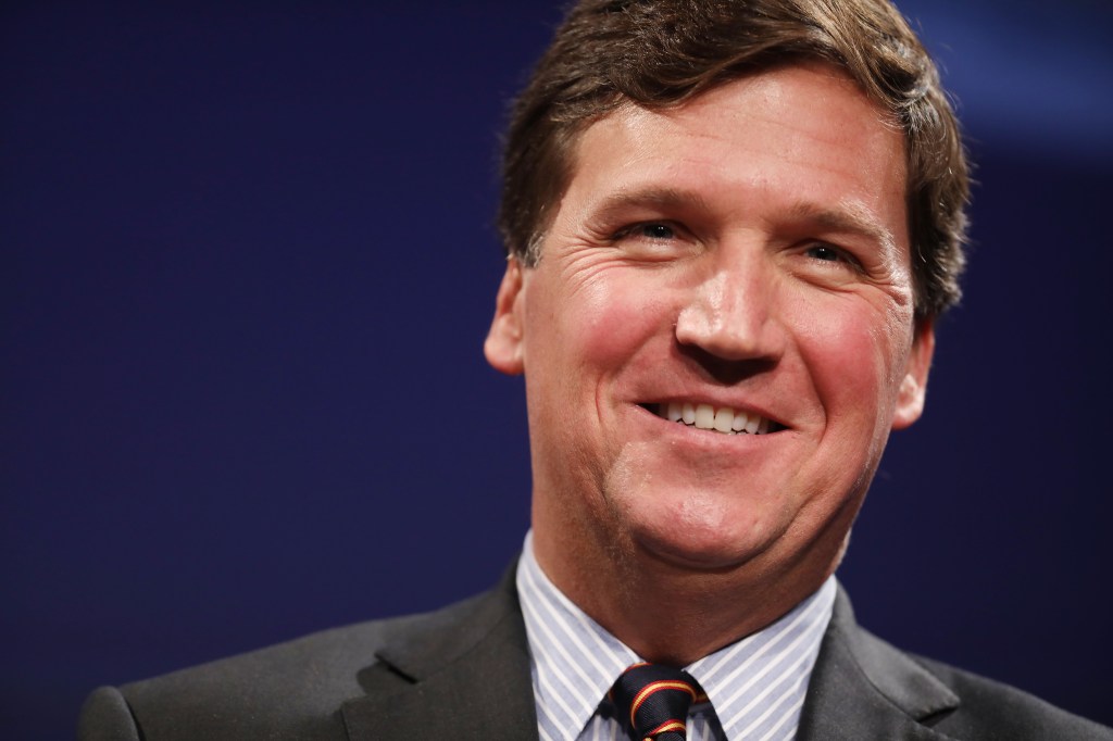 Tucker Carlson looking happy.