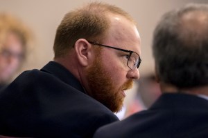 Travis McMichael speaks to his attorney Robert Rubin during the trial for Ahmaud Arbery's shooting death at the Glynn County Courthouse on November 9, 2021 in Brunswick, Georgia.