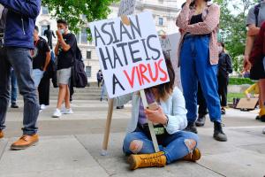 A protester at a Stop Asian Hate rally as hate crimes triple during the course of the pandemic in the UK.​ Photo: Eleventh Hour Photography / Alamy Stock Photo​