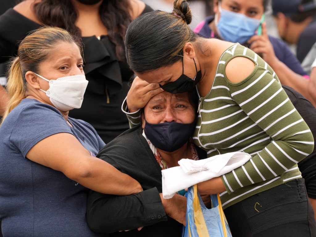 Relatives wait outside the morgue for news on their relatives who were inmates at the Litoral penitentiary, after deadly riots broke out inside the prison in Guayaquil, Ecuador