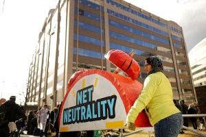 Protesters carry a clock-shaped prop during a demonstration against the repeal of net neutrality in 2017.