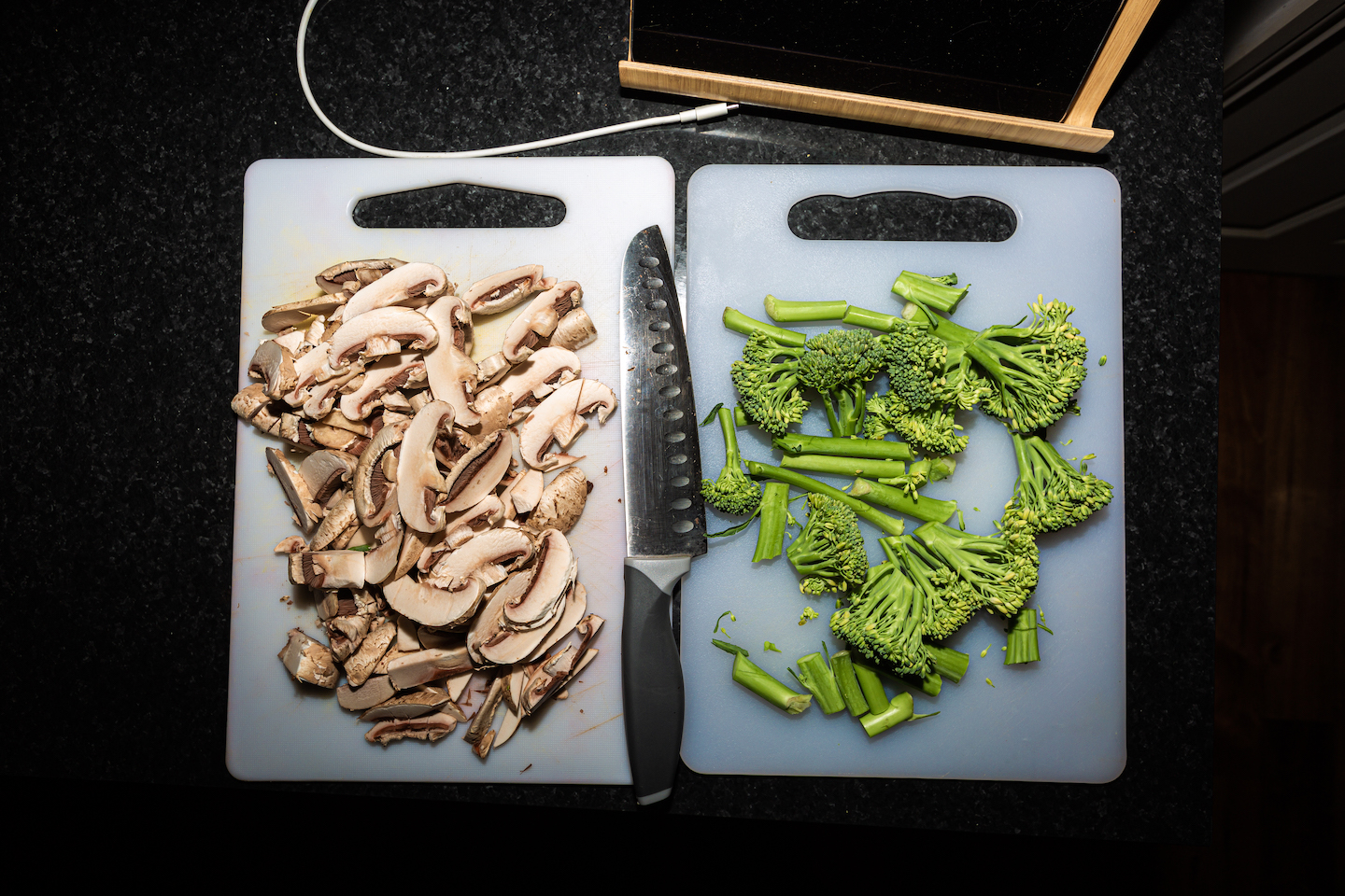 Sliced mushrooms and broccoli on chopping boards