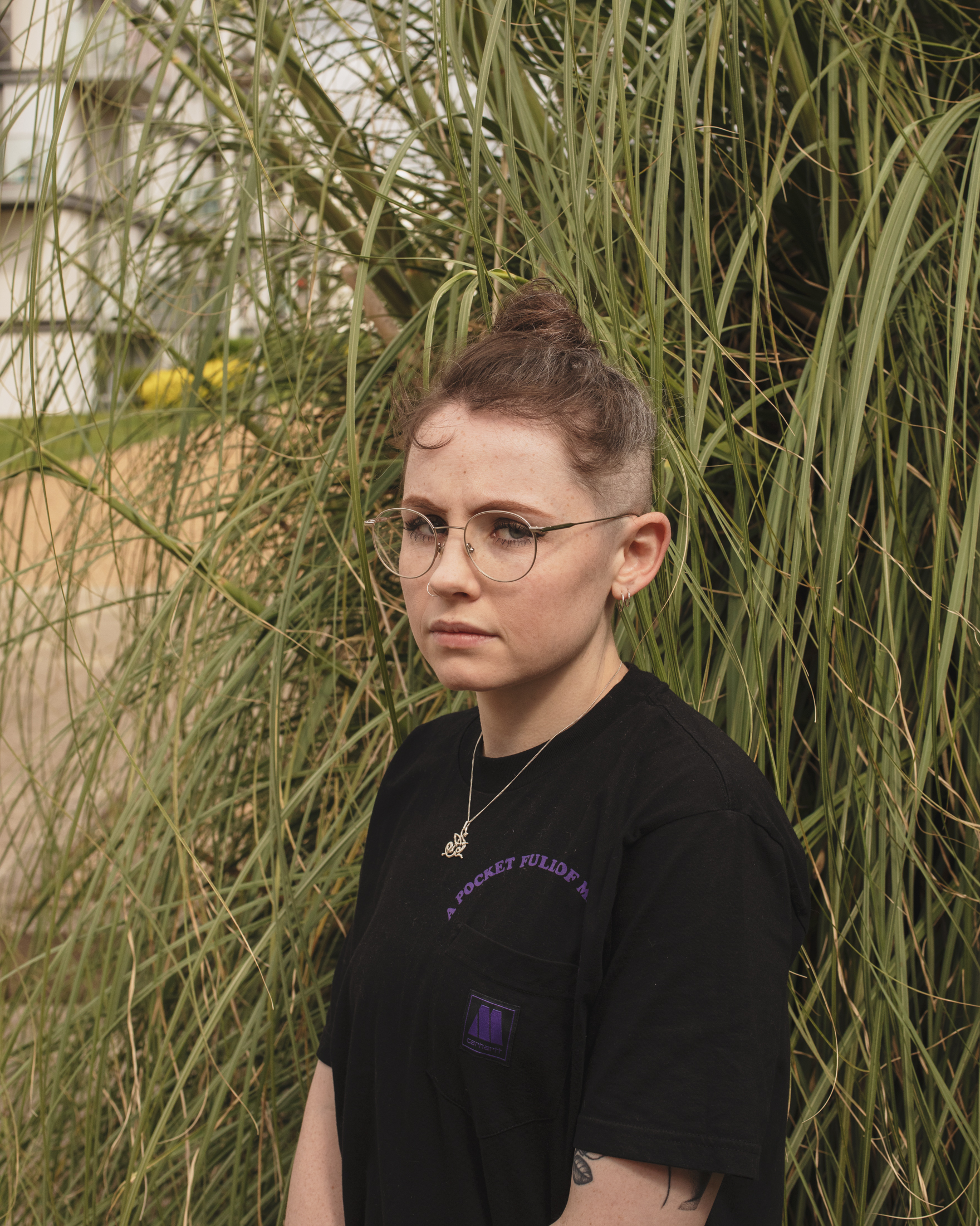 Long covid patient Nia Wynn standing against some foliage