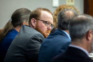 Travis McMichael sits with his attorneys before the start of closing arguments to the jury during the trial of he, and his father Greg McMichael, and William "Roddie" Bryan, at the Glynn County Courthouse, Monday, Nov. 22, 2021, in Brunswick, Ga.