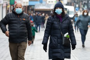 Shoppers wear masks on Nov. 29 in Windsor, United Kingdom after the announcement of the Omicron variant's presence in the UK. (Photo by Mark Kerrison / In Pictures via Getty Images)​