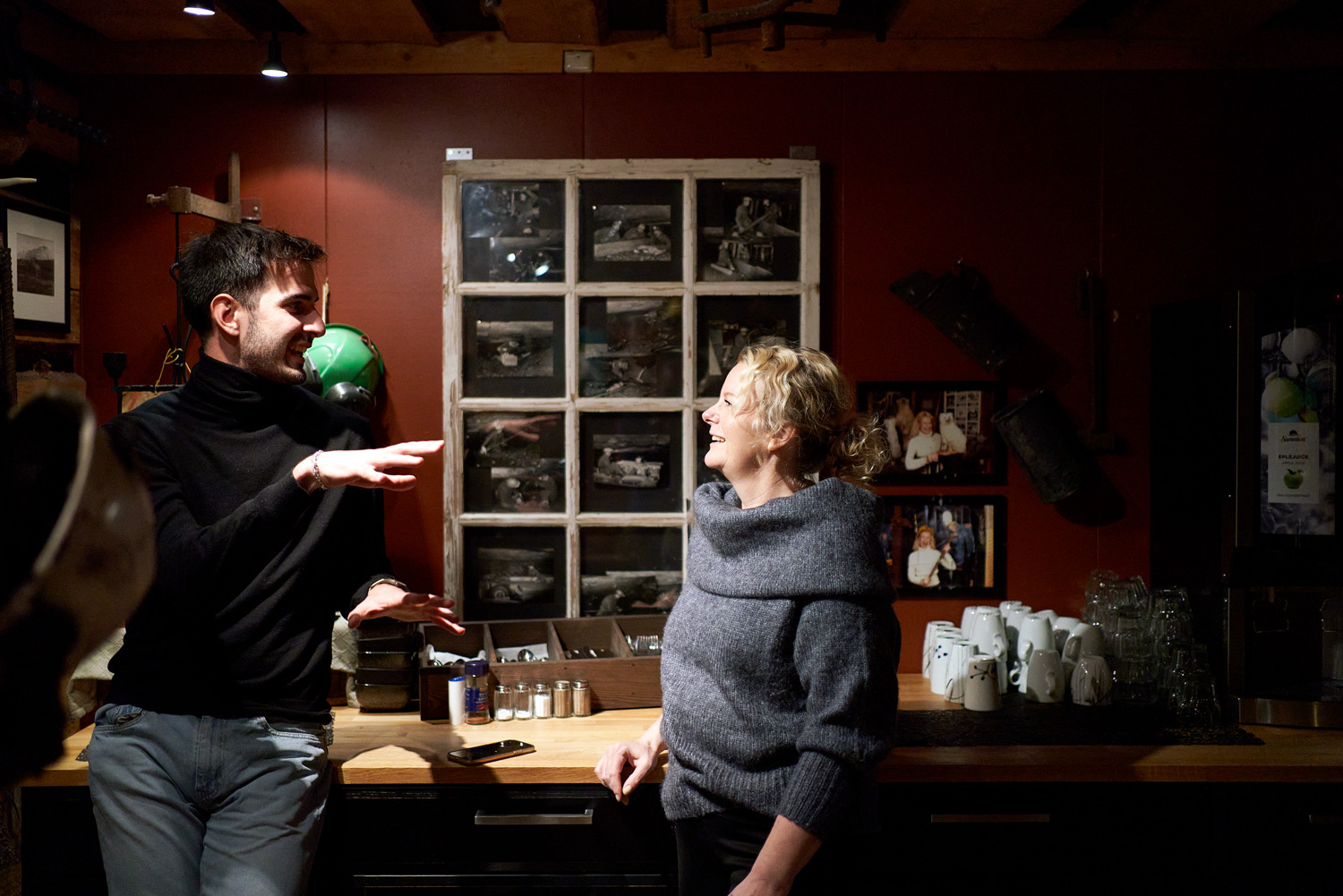 Arctic cuisine, Svalbard, Nick Casini - Photo of man in black roll-neck jumper talking to a woman in a grey roll-neck jumper.