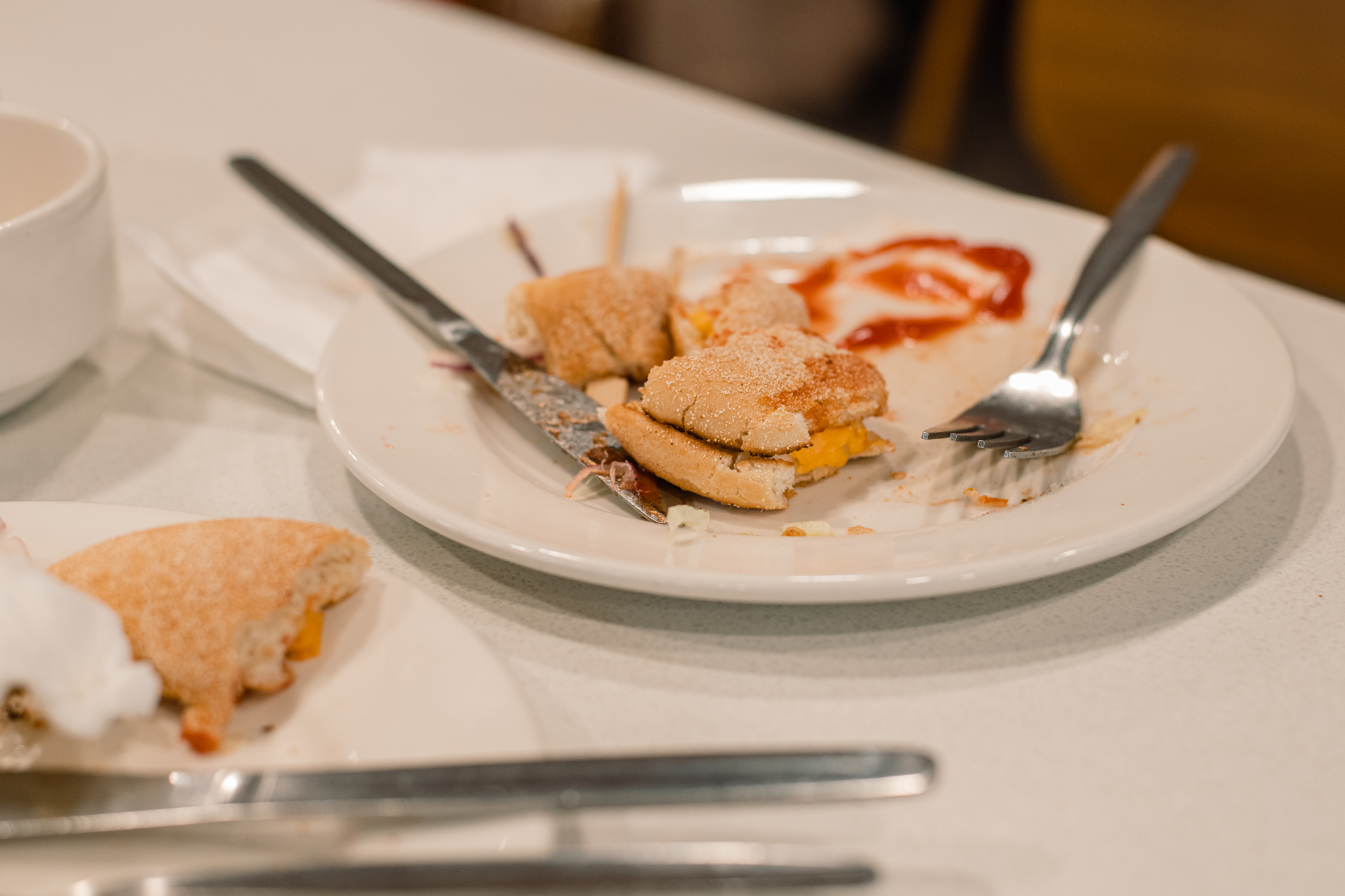 The remains of a Wimpy burger on a plate.