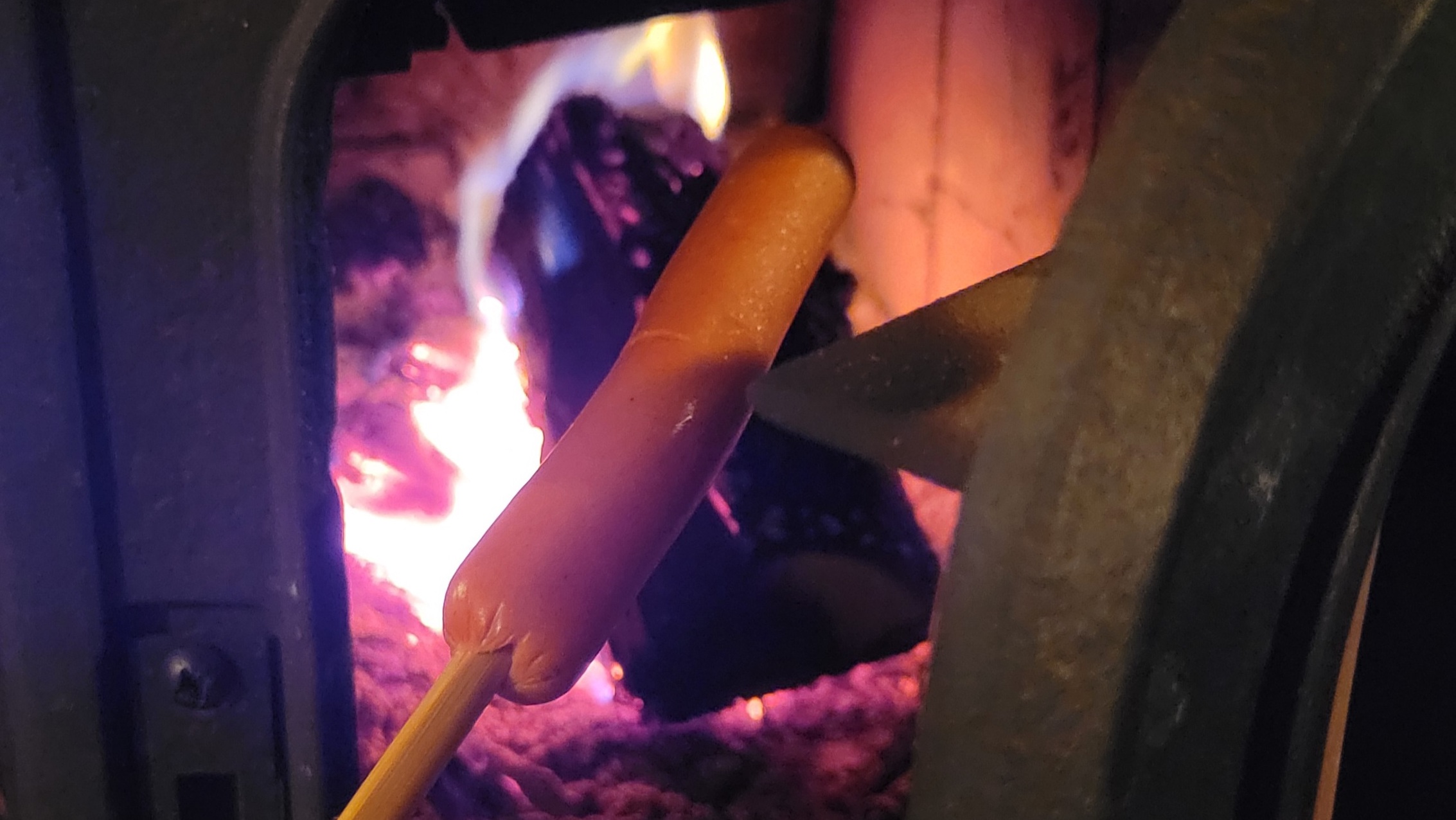 Cooking hot dogs in the wood stove because fuck it. Photo by author