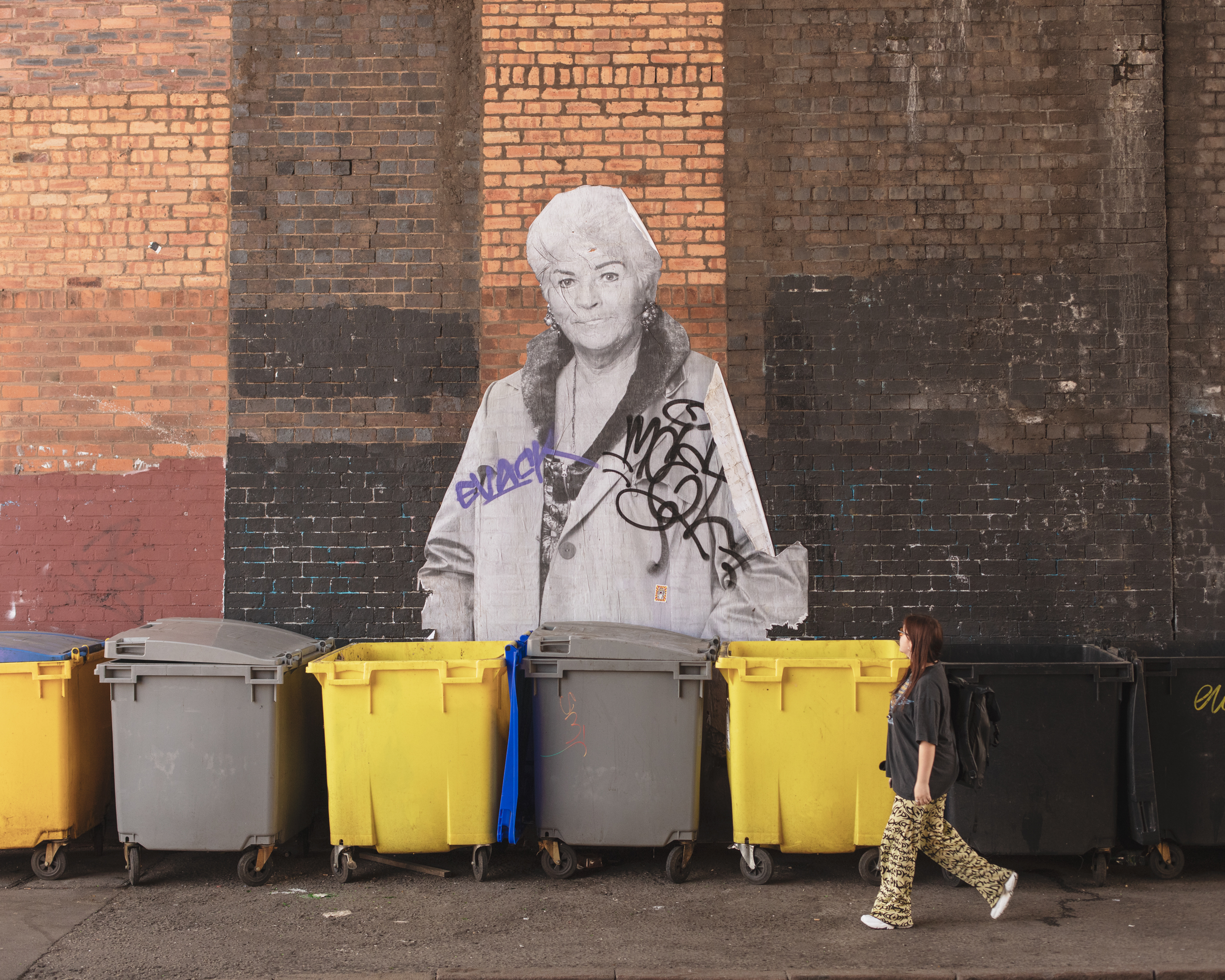 VICE writer Lauren O'Neill in Birmingham walking past a mural of Pat Butcher from EastEnders