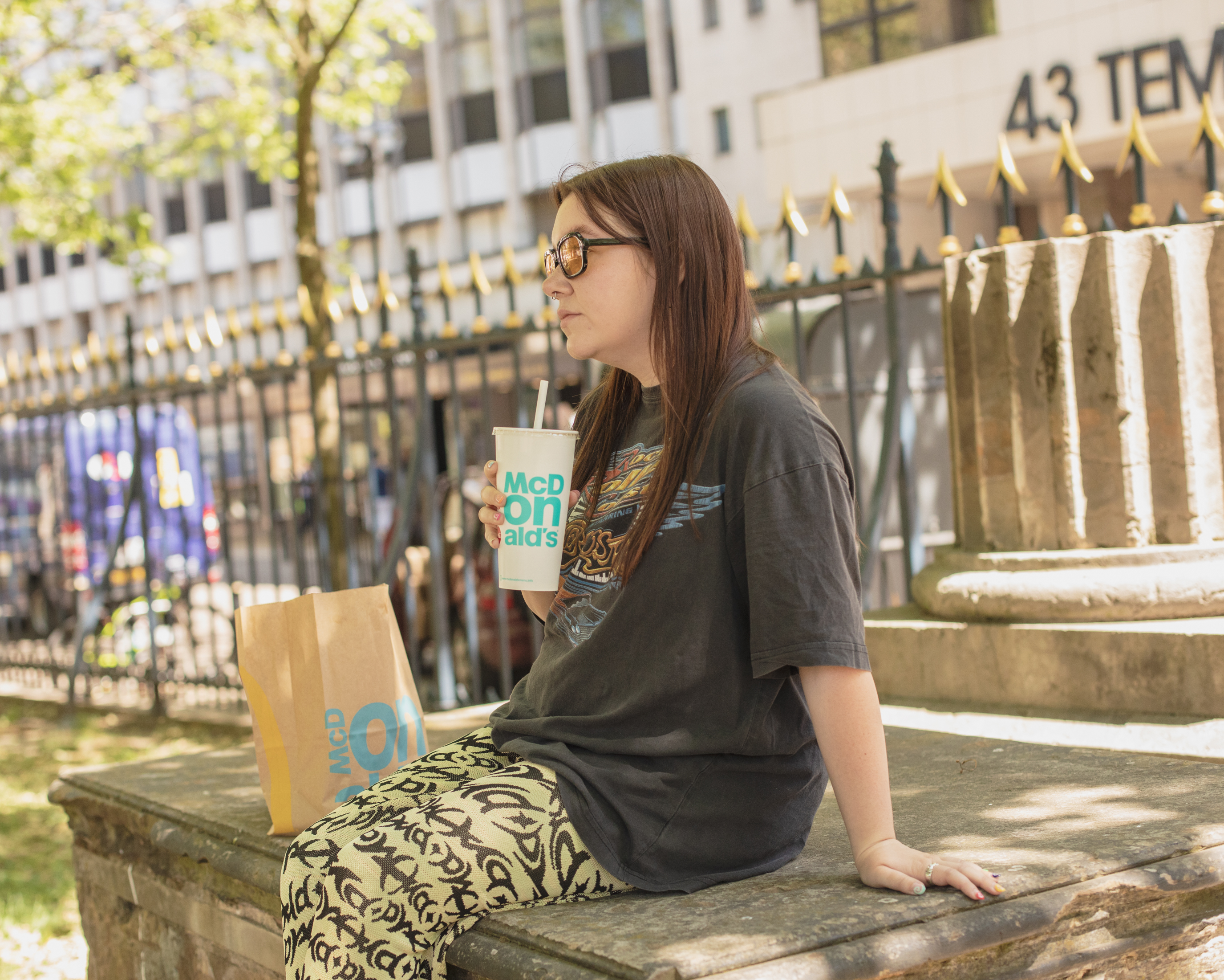 VICE writer Lauren O'Neill in Birmingham in a churchyard with a McDonald's