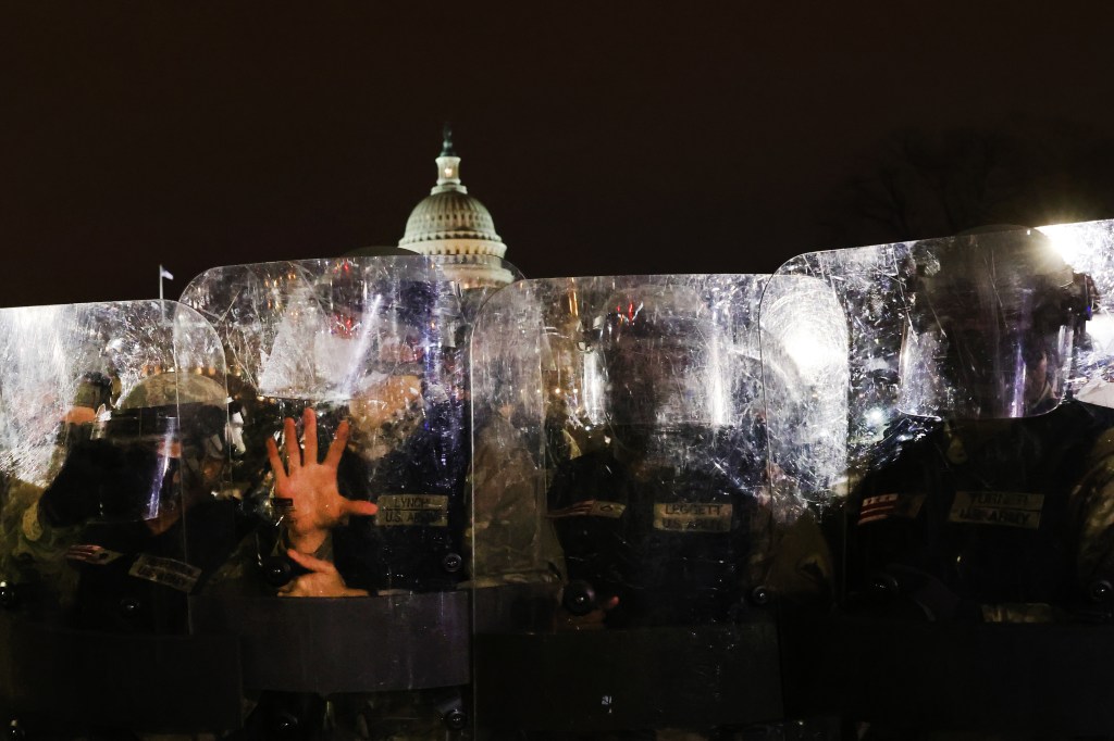 Members of the National Guard and the Washington D.C. police keep demonstrators away from the Capital on January 6, 2021.