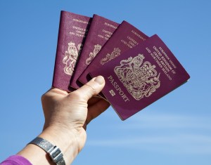 Man holding four British passports