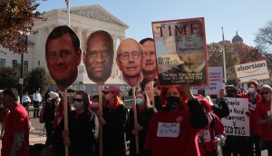 Demonstrators carry large cut-outs of members of the U.S. Supreme Court as the justices heard arguments in Dobbs v. Jackson Women's Health, a case about a Mississippi law that bans most abortions after 15 weeks, on December 01, 2021 in Washington, DC. ​