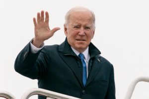 President Joe Biden waves as he boards Air Force One upon departure, Wednesday, Dec. 8, 2021, at Andrews Air Force Base, Maryland.