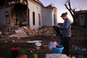 Jessica Hart salvages items from a home that was destroyed after a tornado ripped through town Friday evening on December 12, 2021 in Mayfield, Kentucky.