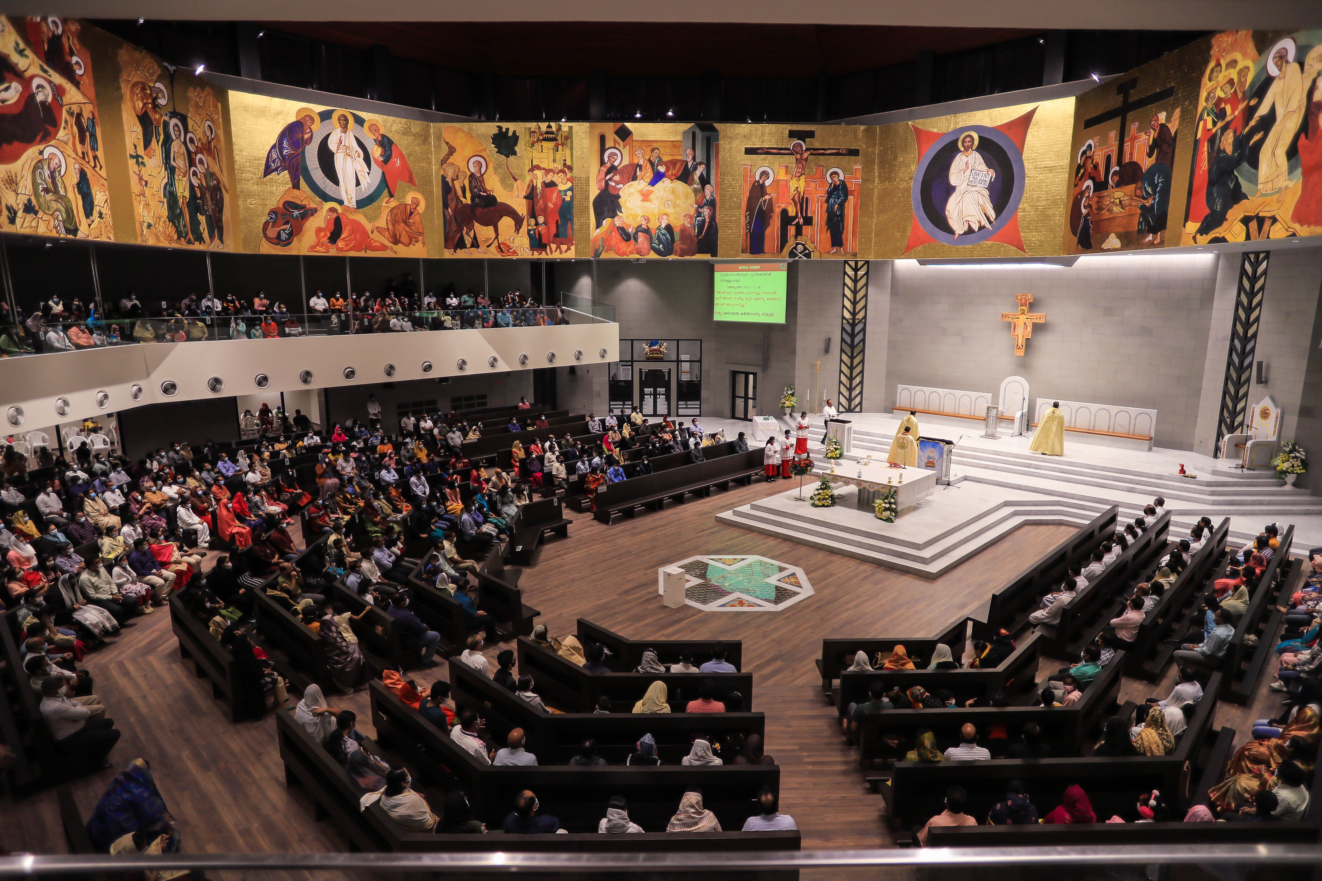 People attend the first mass of the cathedral. Photo: Ayman Yaqoob/Anadolu Agency via Getty Images