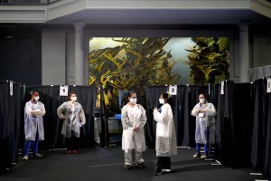 Healthcare workers wait in front of privacy booths at the American Museum of Natural History Covid-19 vaccination site in New York, U.S., on Friday, April 30, 2021.