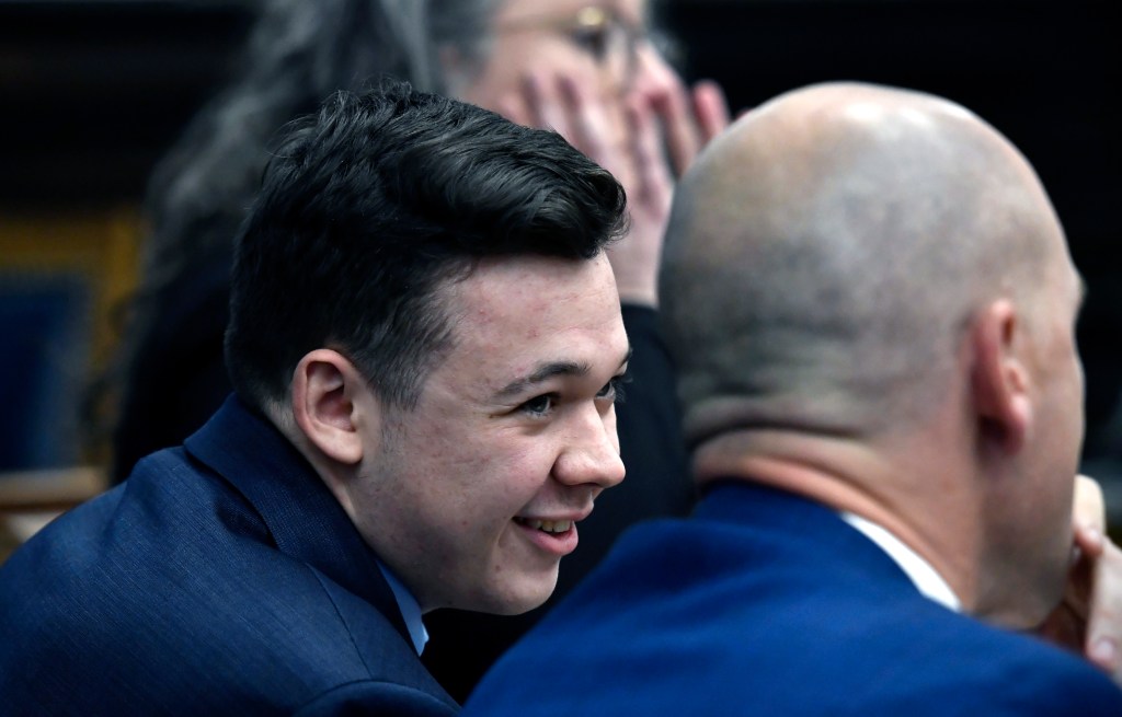 Kyle Rittenhouse speaks with his attorneys during his trial on November 18, 2021 in Kenosha, Wisconsin.