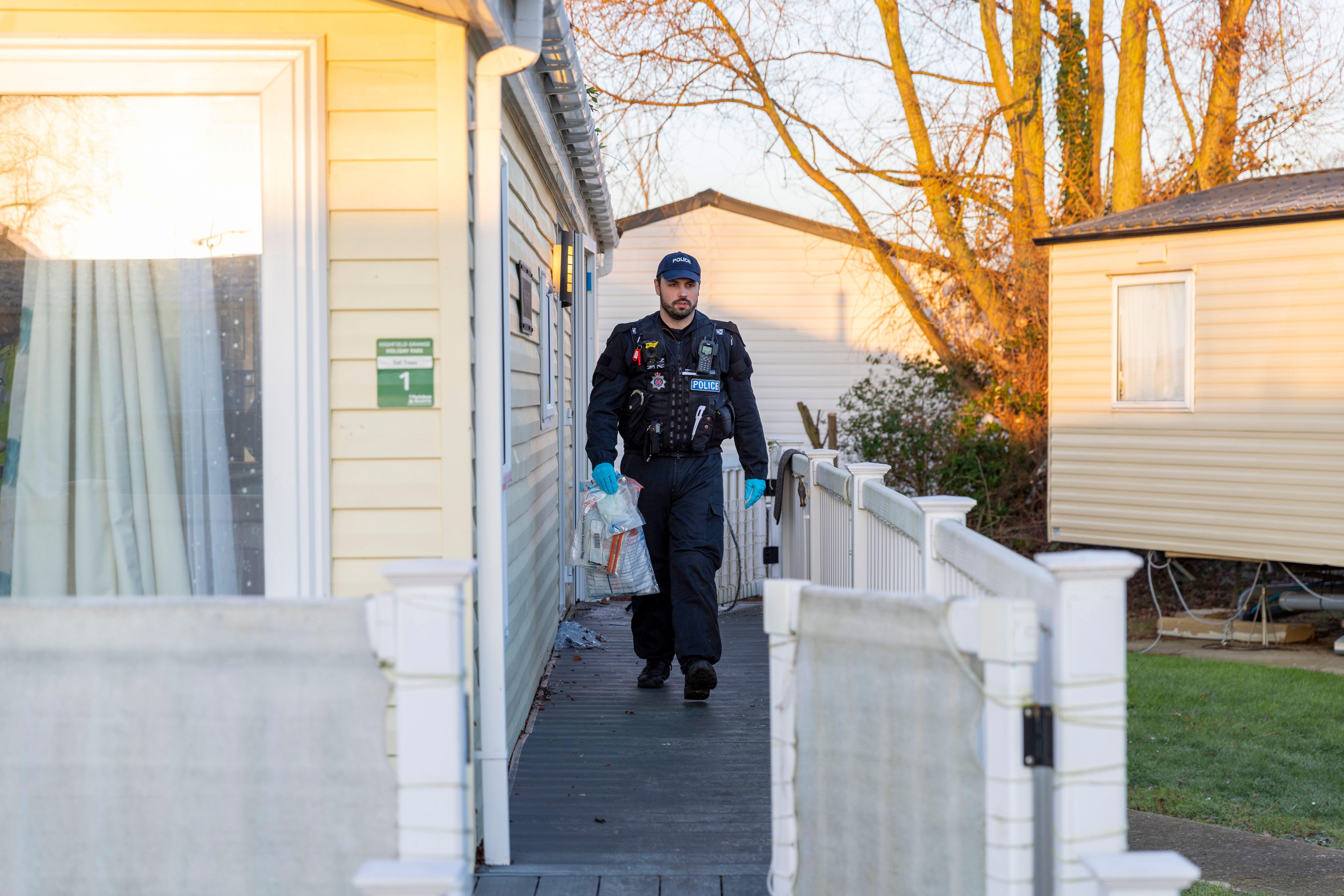 An Essex Police officer removing contraband from a house in Clacton, Essex on a drugs raid.