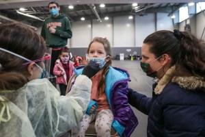 A nurse administers a test swab to Emry Acevedo, 4, at a COVID19 testing site established by San Bernardino County Department of Public Health, Dec. 30, 2021. (Irfan Khan / Los Angeles Times via Getty Images)​