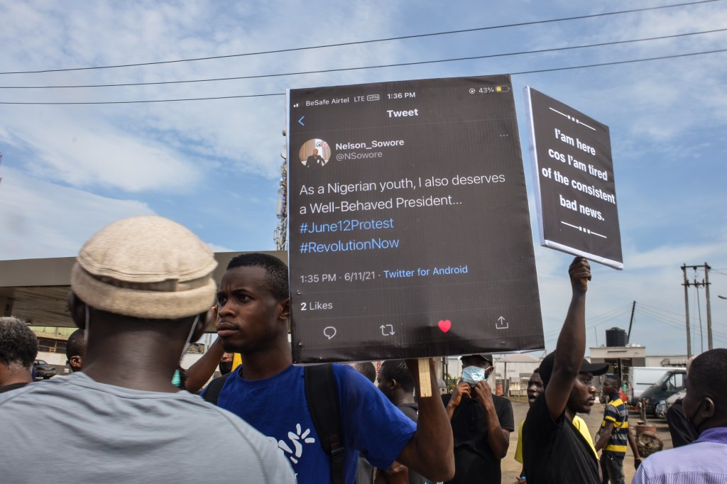 Protesters hold banners during civil demonstration at the Gani Fahweyinmi Park, Ojota district of Lagos, Nigeria, venue of the June 12 protest​.