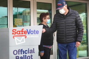 Residents drop mail-in ballots in an official ballot box outside of the Tippecanoe branch library on October 20, 2020 in Milwaukee, Wisconsin.