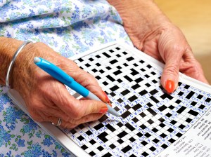 A person does a crossword puzzle