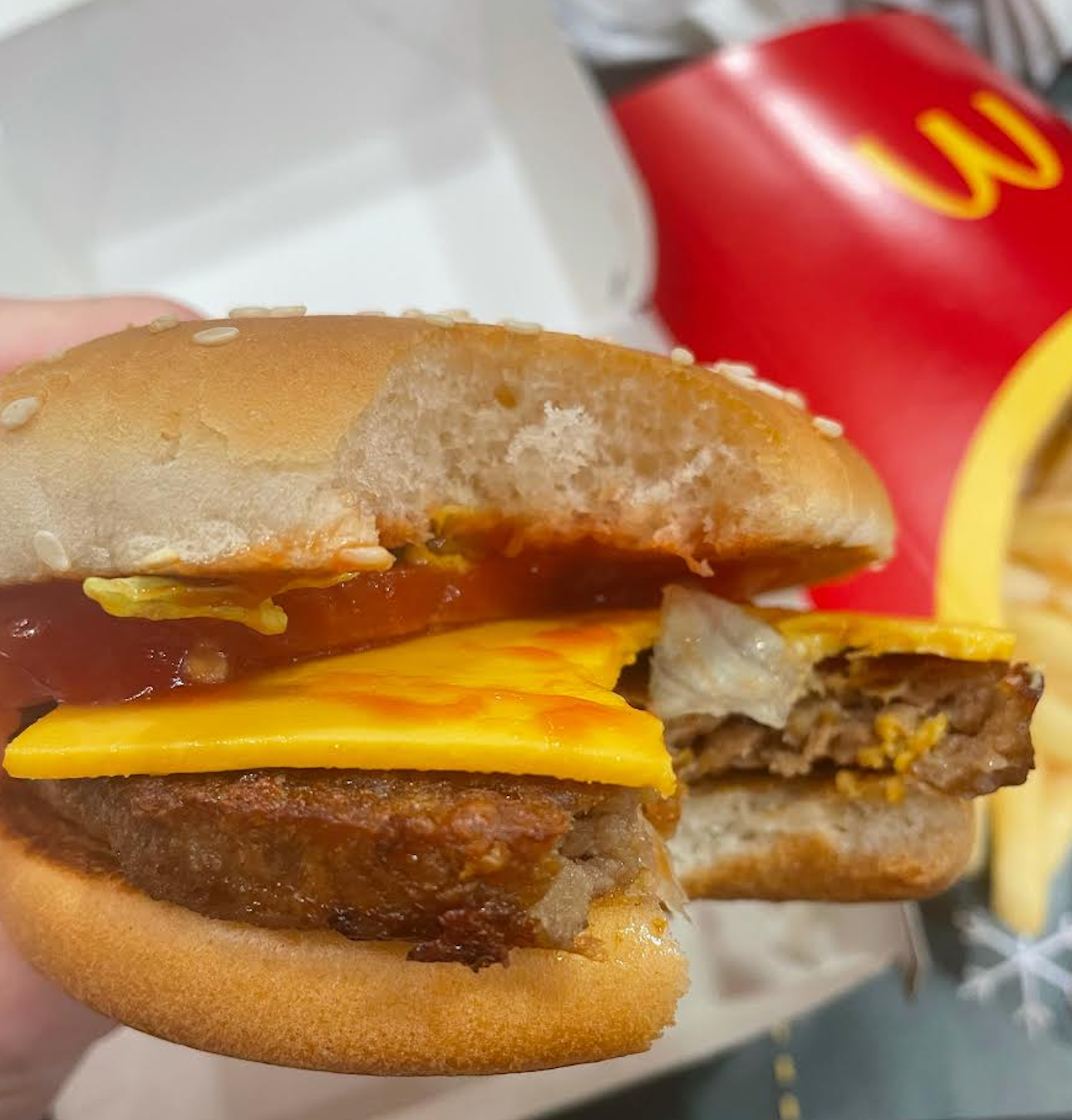 A hand holding the McDonald's McPlant burger