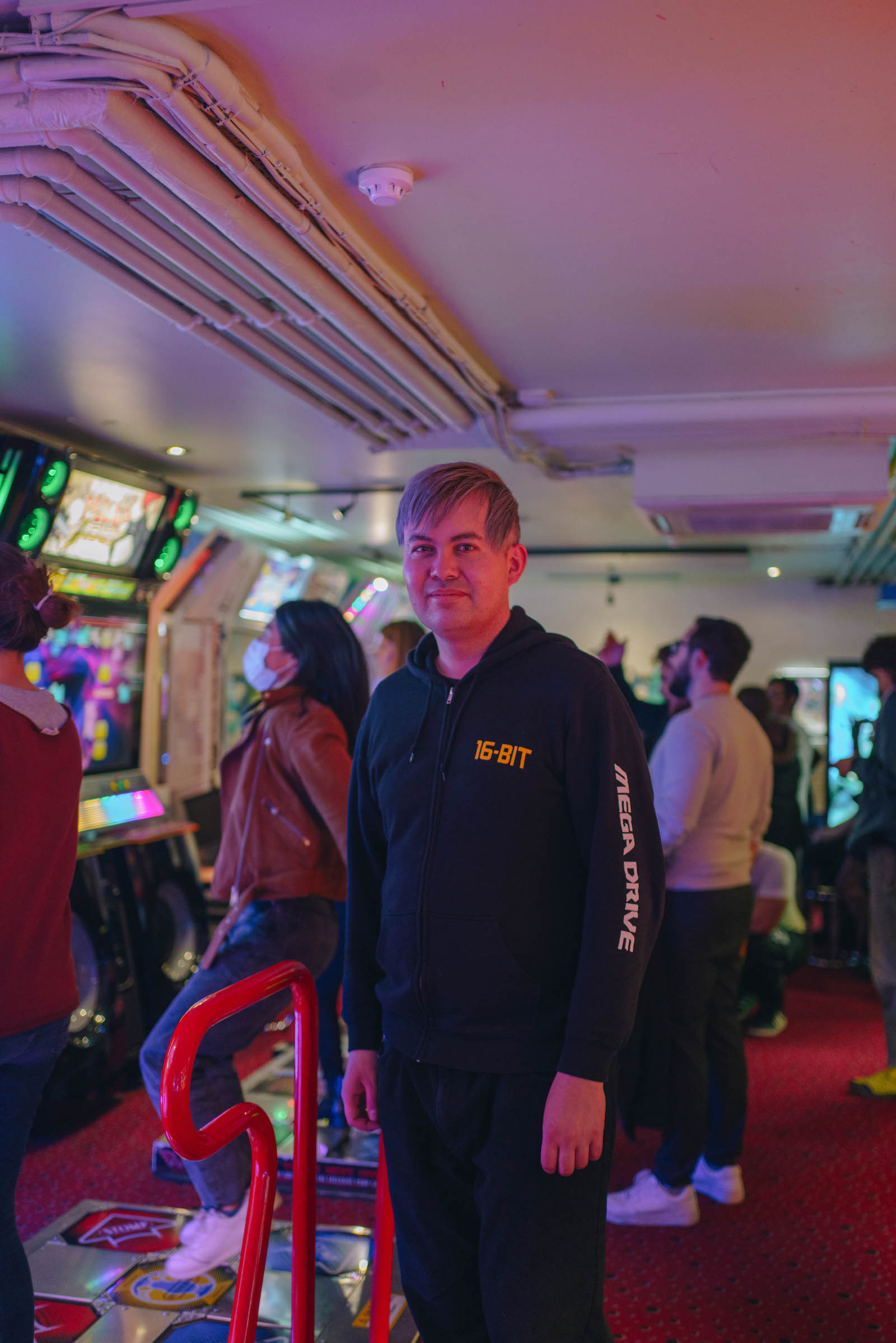 Rhythm game fan Toby Nakhorn stands in an arcade