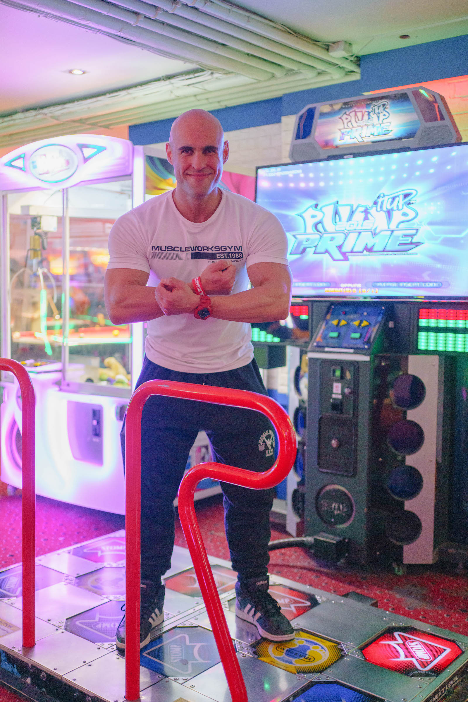 Former Mr Ireland winner Patrick stands on a Pump arcade game