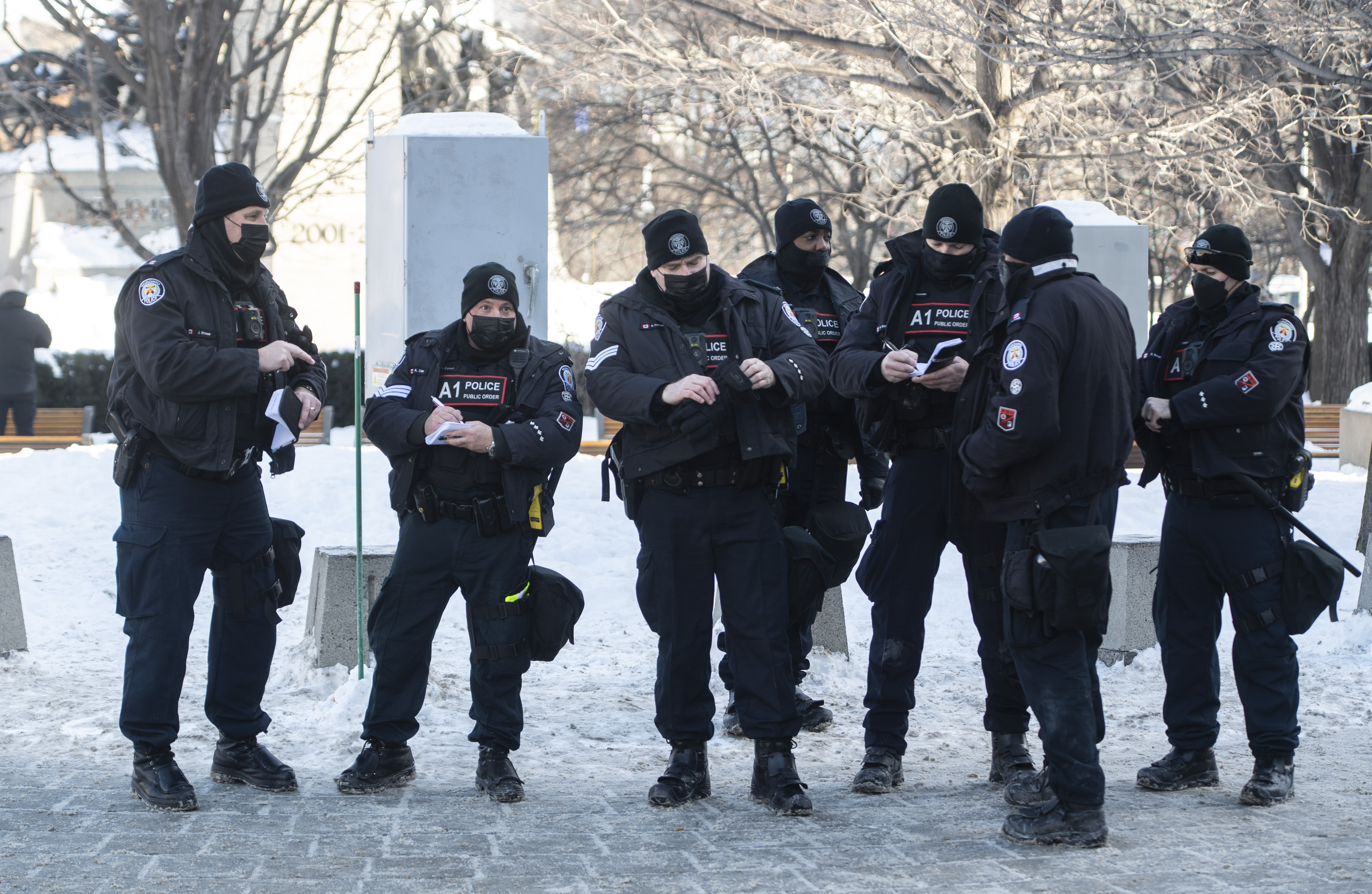 Police work on the grounds of the National War Memorial. Ottawa police said their costs were $800,000 a day. 