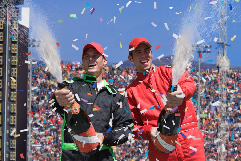 Rich F1 drivers celebrating with champagne